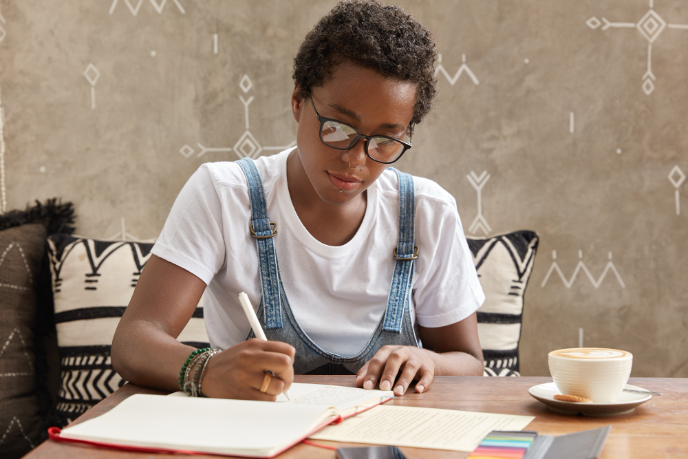 ambitious-teenager-with-dark-skin-boycut-makes-necessary-notes-organizer